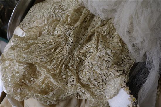 Two ornate babys 19th century christening capes, a silk and lace wedding train, waxed headdress and veil